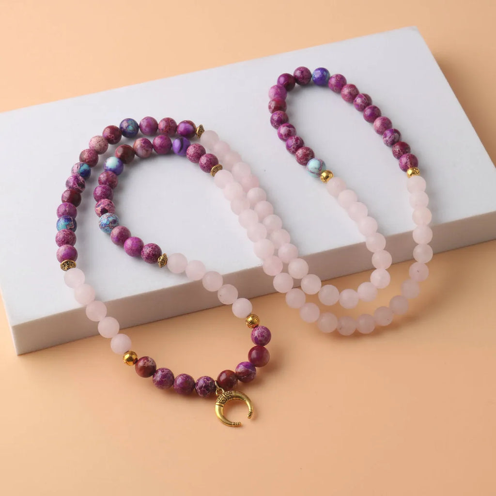 Women's personalised necklace with round Emperor Stone bead pendant showing pink crystal colouration