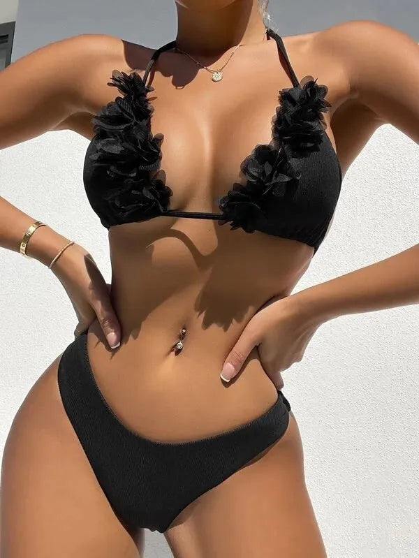 Black women's two-piece swimsuit set with a gathered design top and matching shorts on a neutral background.