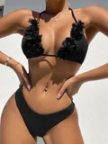 Black women's two-piece swimsuit set with a gathered design top and matching shorts on a neutral background.