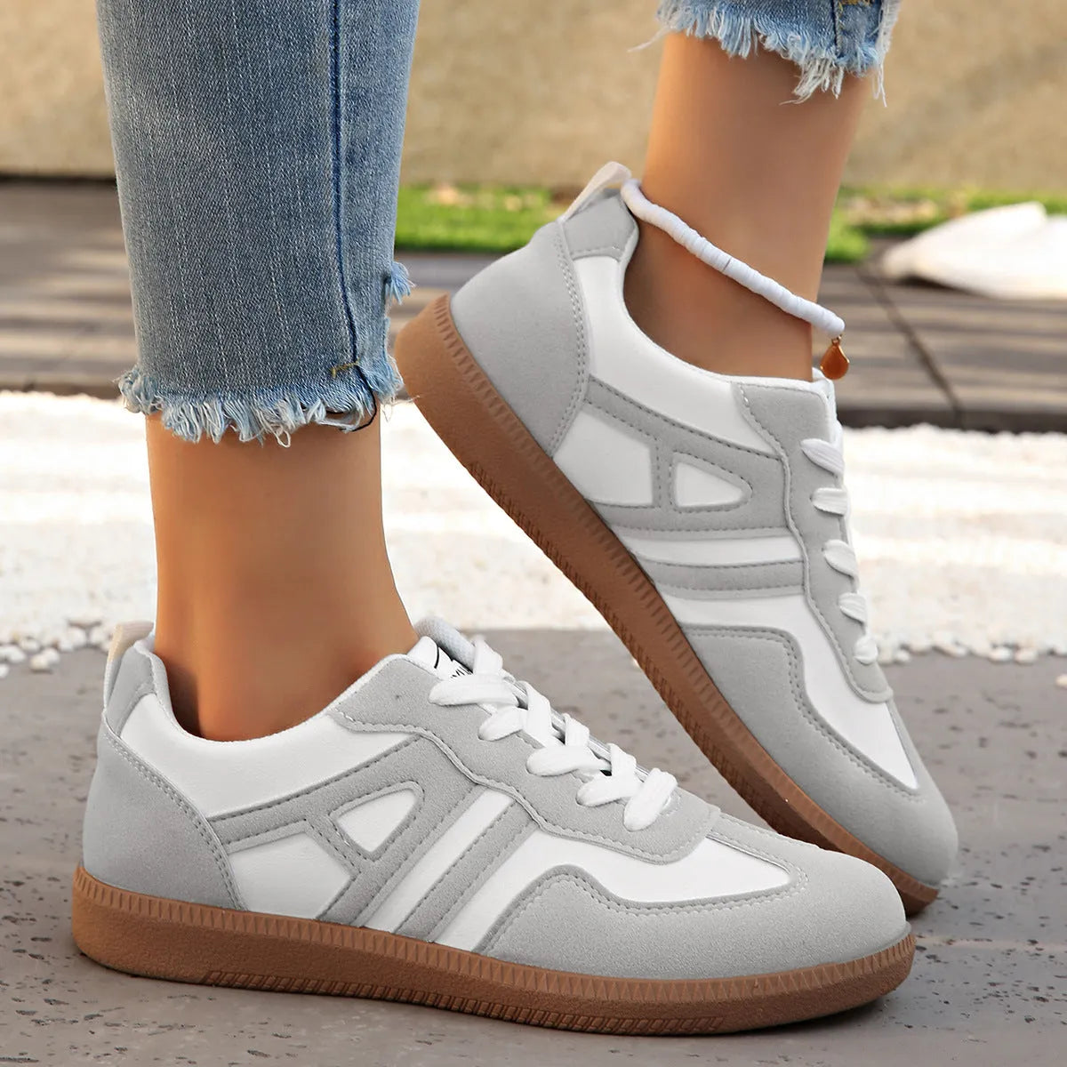 Women's retro lace-up jogging shoes in black, grey, and khaki colours showing round toe and platform heel.