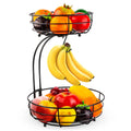 Double-tier black wrought iron fruit basket filled with assorted fruits on a countertop