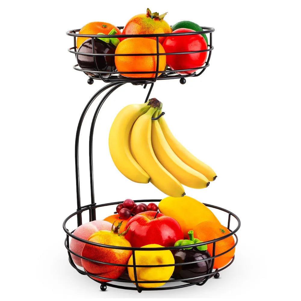 Double-tier black wrought iron fruit basket filled with assorted fruits on a countertop