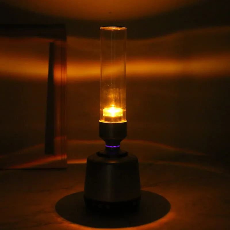 White silver Bluetooth speaker with candlelight night light showing push button controls and modern simple design