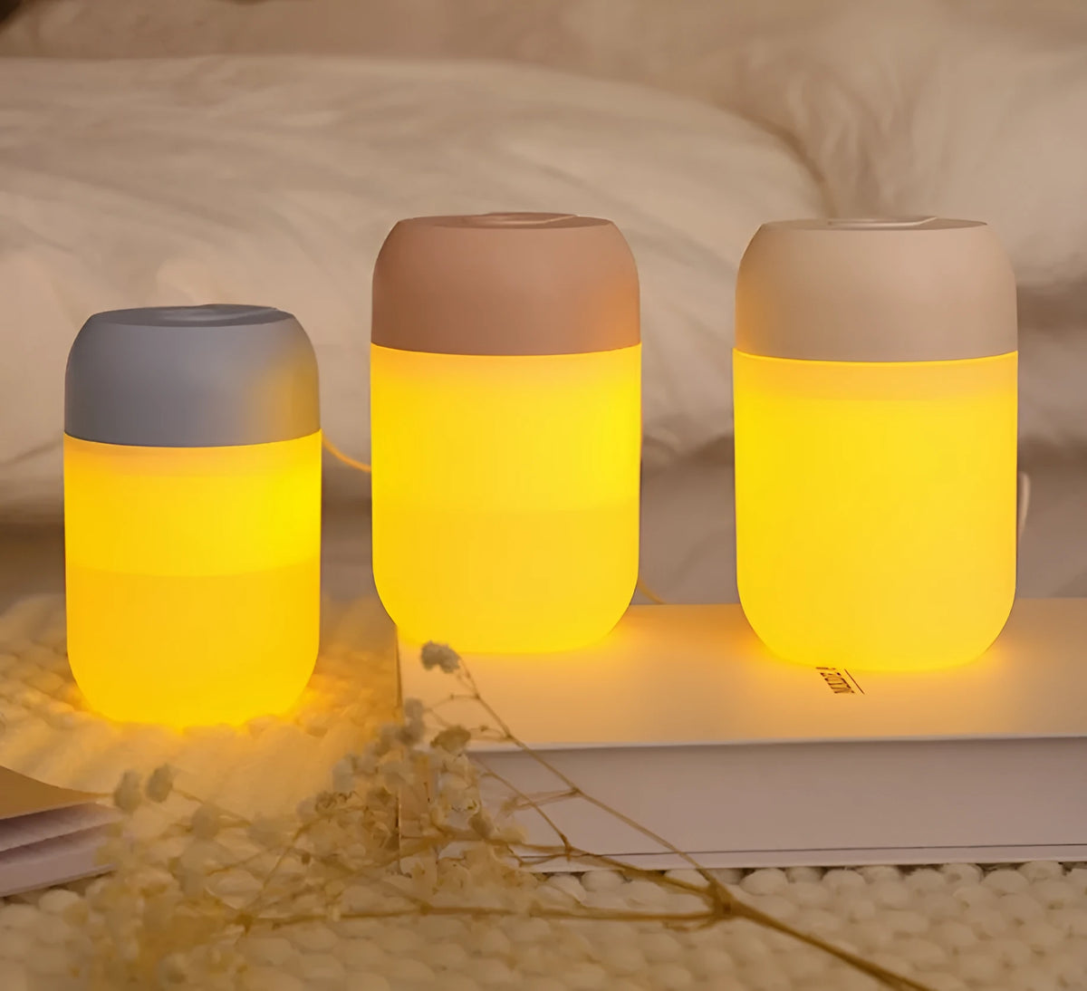 White cylindrical USB mini humidifier with charging cable on flat surface