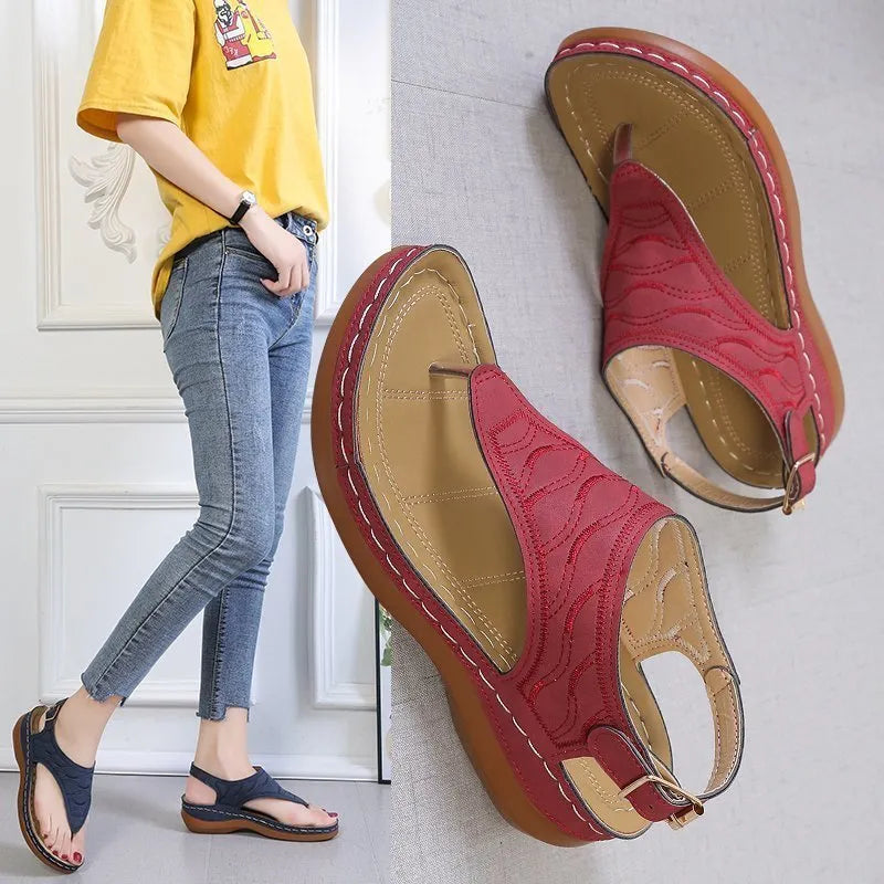 Women's casual wedge heel sandals with an adjustable buckle strap in red.