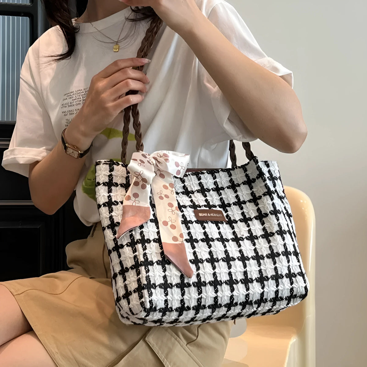 Black woolen shoulder bag with horizontal square shape and internal organisation compartments