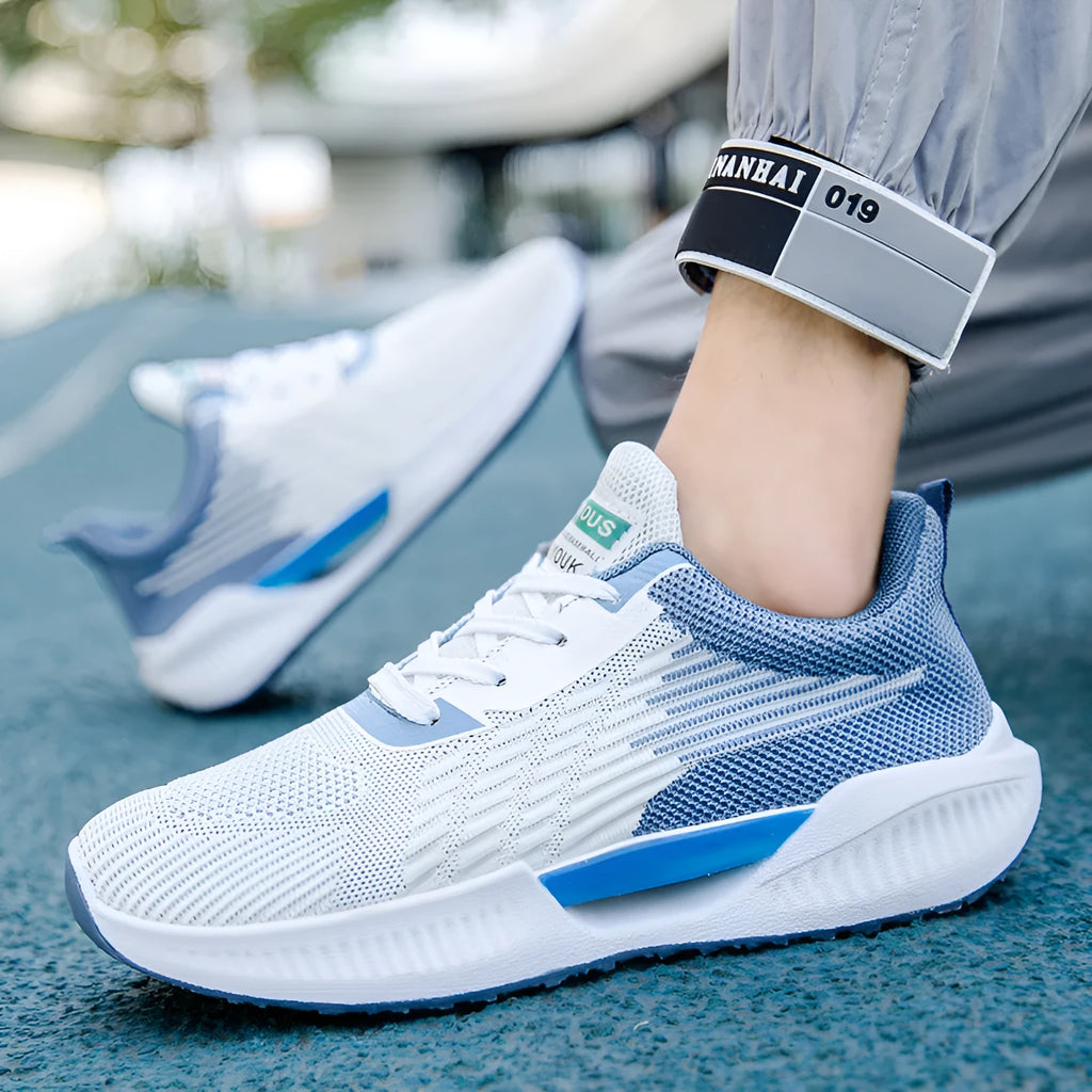Men's blue mesh casual shoe with round toe and cloth upper, displayed on a white background.