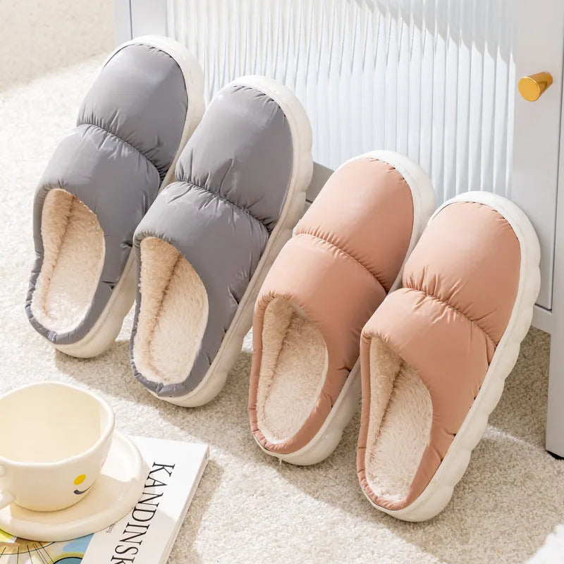 Blue down cotton slippers with a thick rubber sole and plush lining for indoor winter wear.