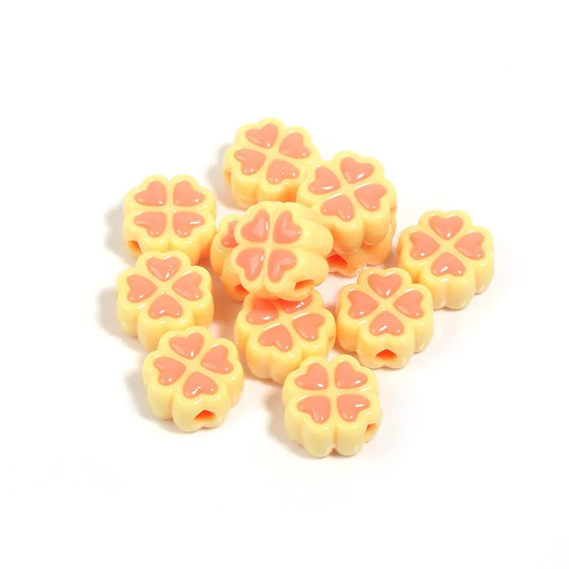 15mm acrylic clover-shaped beads with love pattern in multiple pastel colours including rose red, pink, yellow, green, blue, and purple