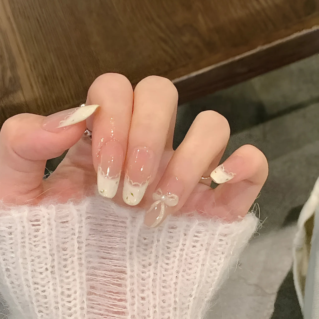 Glossy false nails with transparent pink French tip design showing 10 complete sets