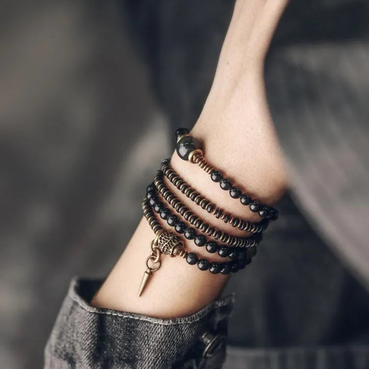 Geometric black beaded bracelet with multi-layered construction and colourful detailing