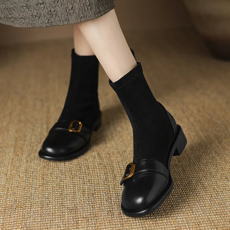 Black women's low heel Martin boots with belt buckle stitching and round toe.