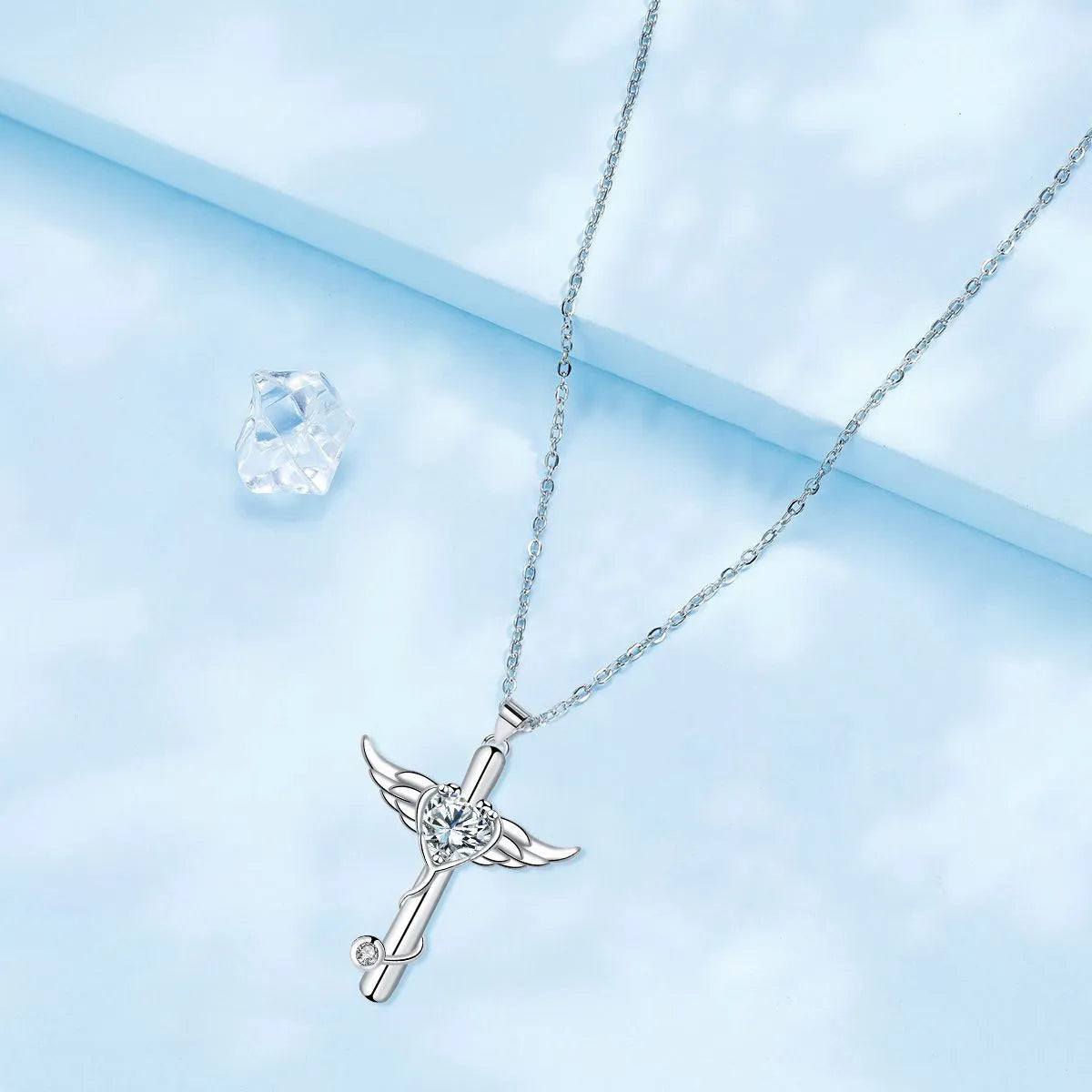Close-up of a copper stethoscope cross pendant with wing details on a chain, available in Red Diamond or White Diamond finish.