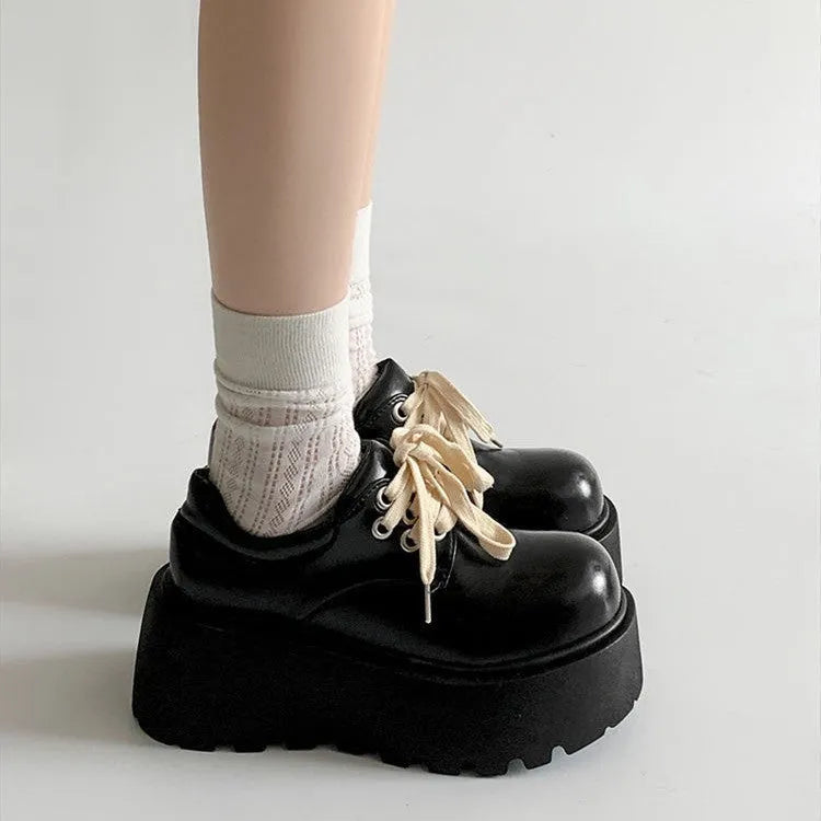 Matte black women's lace-up buckle boots with a thick sole and 6-8cm chunky heel on a white background.