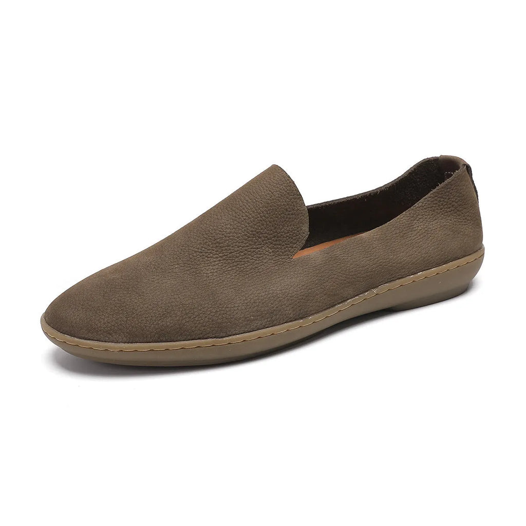 Handmade grey low-top men's shoes with a flat wedge heel and rubber sole.