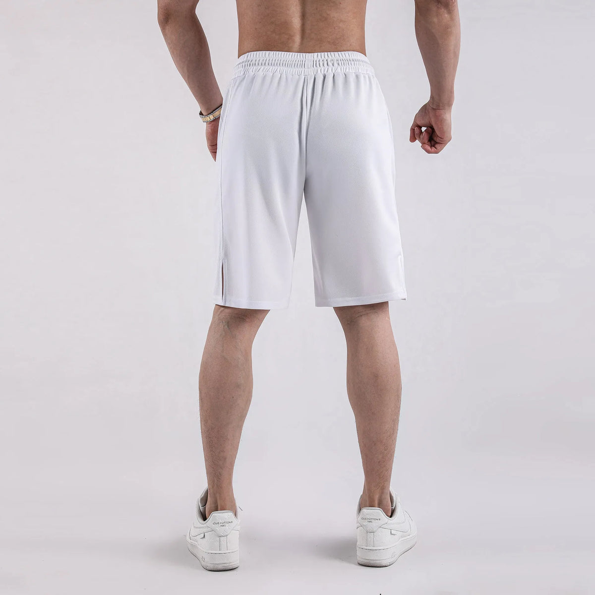 Men's black quick-drying mesh capri shorts with an elastic mid waist on a white background.