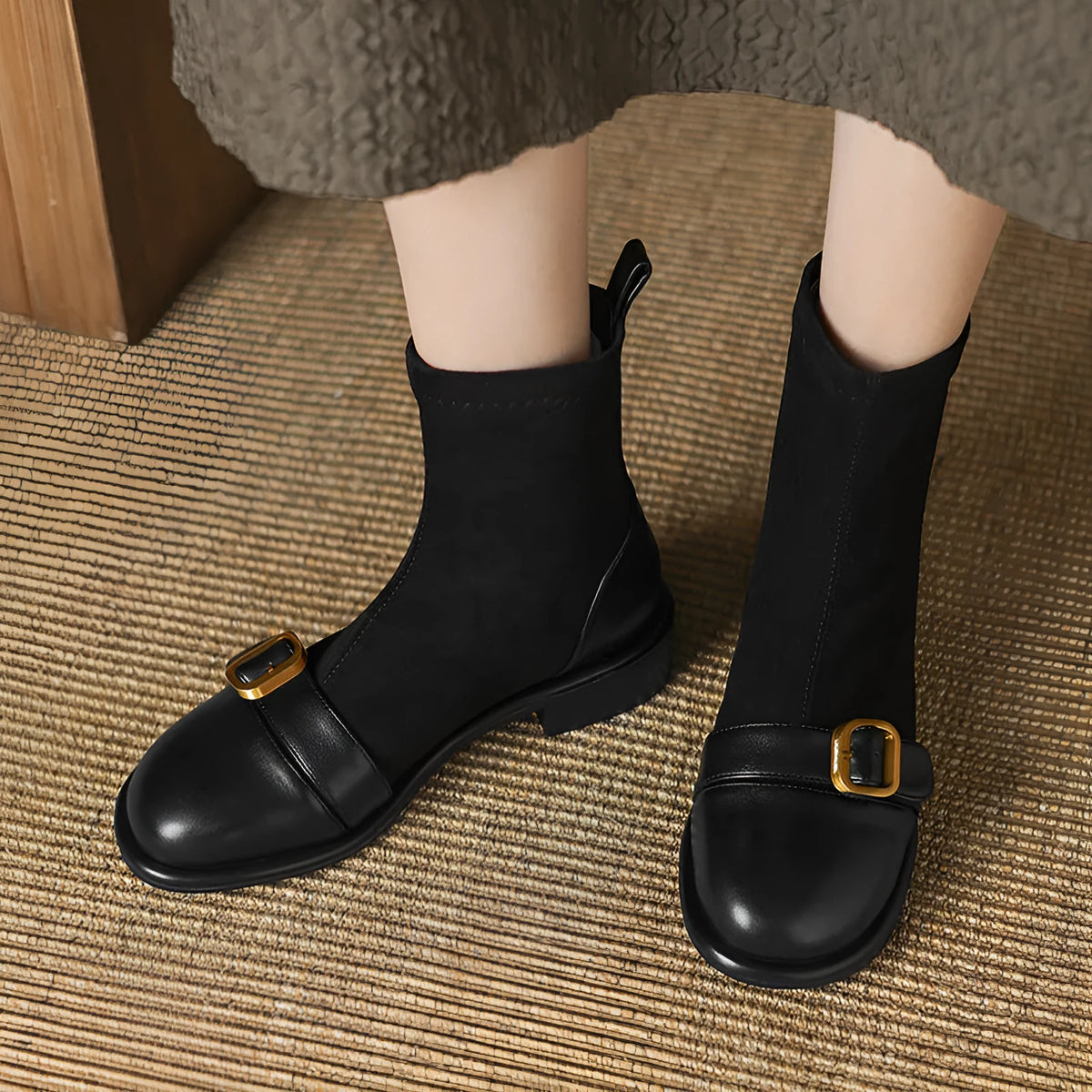 Black women's low heel Martin boots with belt buckle stitching and round toe.