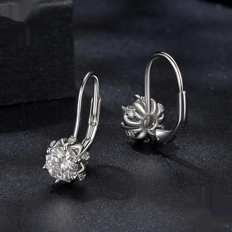 Sterling silver flower bud clip earrings with moissanite stone and white gold plating.