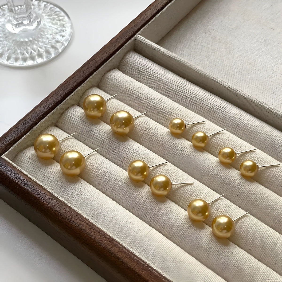 Geometric pearl stud earrings with eight-pointed star design in silver setting