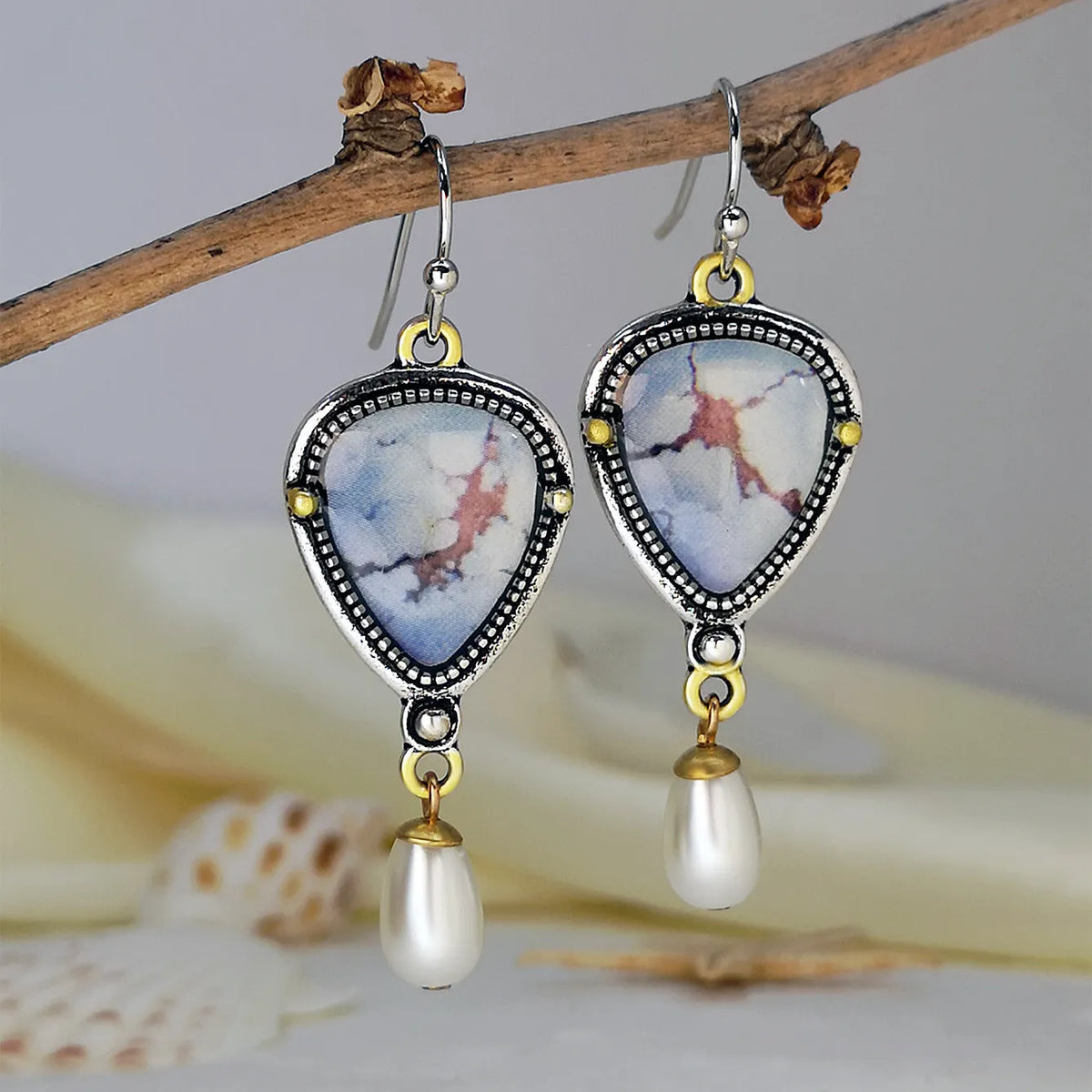 Retro blue bohemian drop earrings with lavender turquoise and pearl elements on geometric metal setting