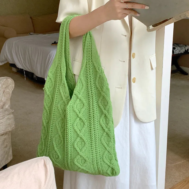 Retro hollow-knitted women's shoulder tote bag in a solid colour, showing double straps and textured fabric.