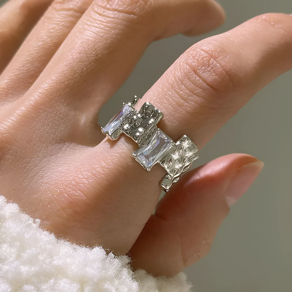 Silver geometric cross ring with open zircon setting and retro design