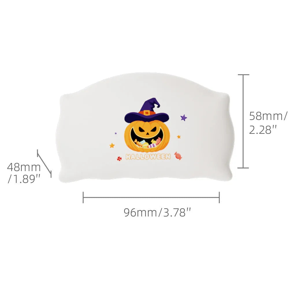 Cartoon Halloween ghost doll table lamp on a desk, showing warm light glow.