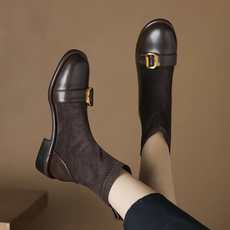 Black women's low heel Martin boots with belt buckle stitching and round toe.