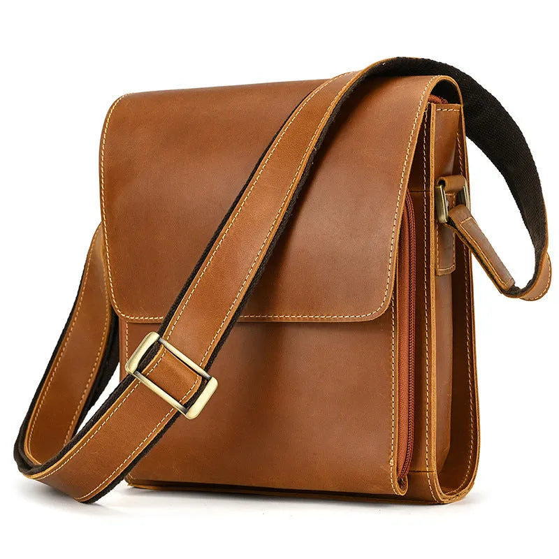 Men's brown cowhide leather crossbody bag with flip shoulder strap and retro style.