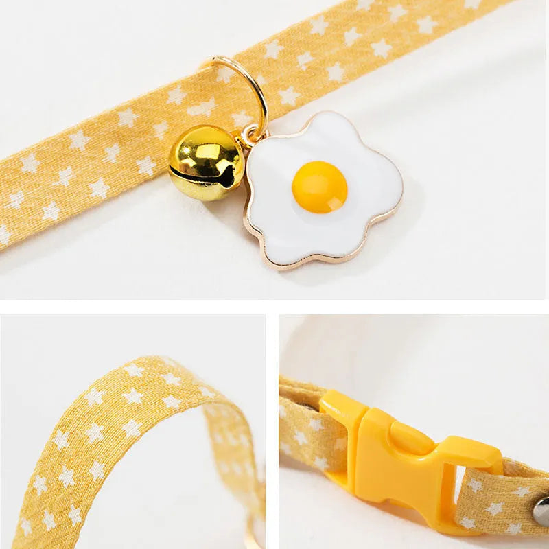 Green adjustable cat collar with a bow tie and bell pendant on a white background.