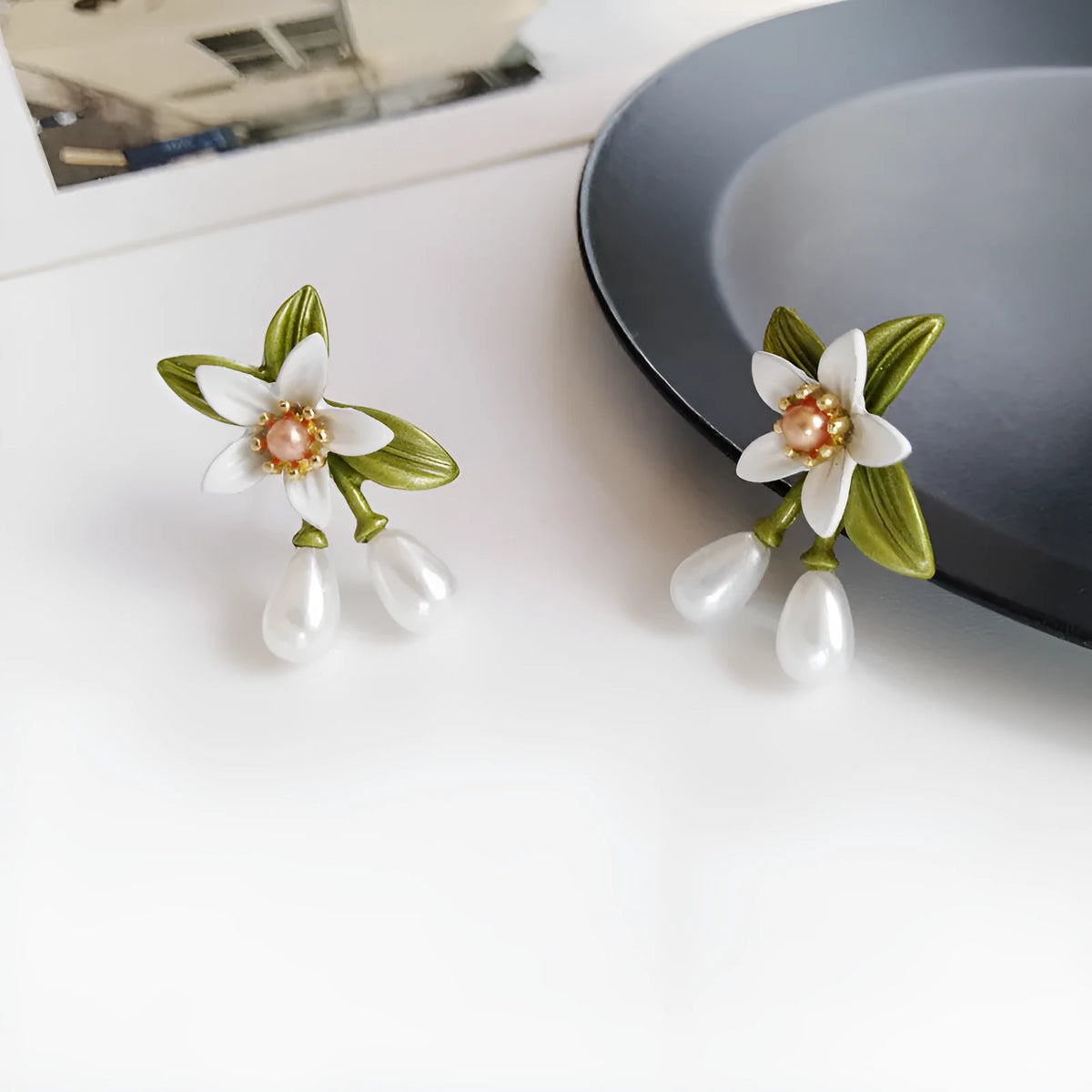 Alloy flower earrings for women, showing stud and clip styles with contrasting colour floral design.
