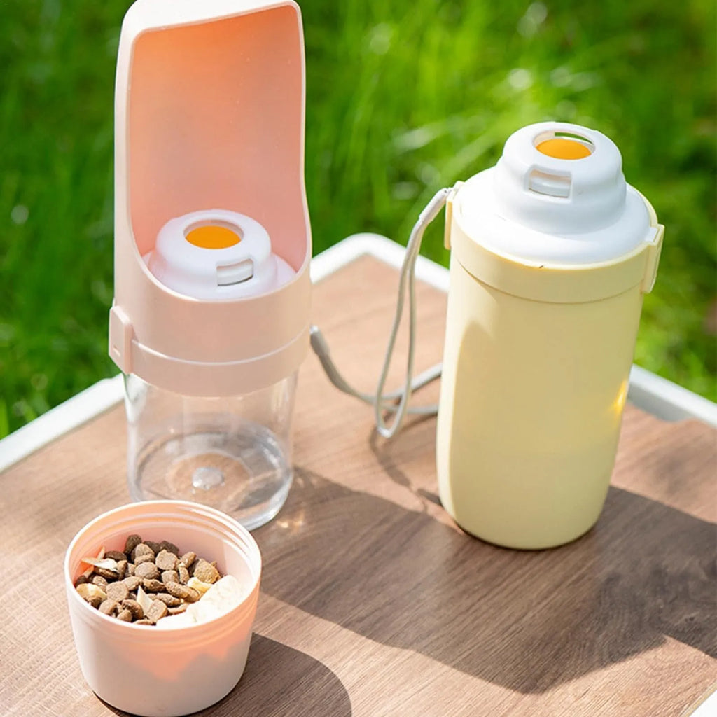 Grey 2-in-1 travel dog water bottle and food dispenser with lanyard attached, showing separate water and dry food compartments