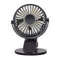 Small white USB rechargeable clip fan with plastic blades attached to a stroller handle.
