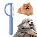 Blue dinosaur-shaped cat brush with double-sided stainless steel bristles and self-cleaning mechanism