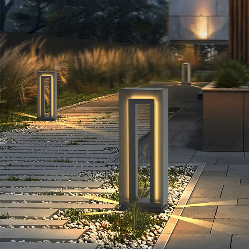 A modern square-shaped stainless steel and acrylic outdoor garden lamp with a geometric design.