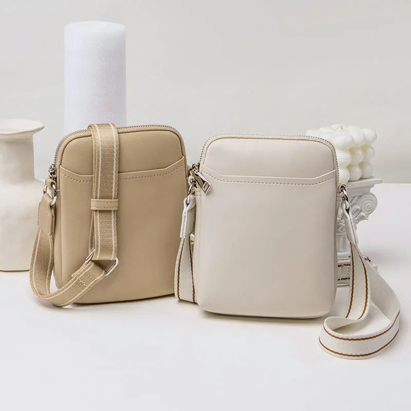 Solid colour PU leather mobile phone crossbody bag showing compact size and shoulder strap.