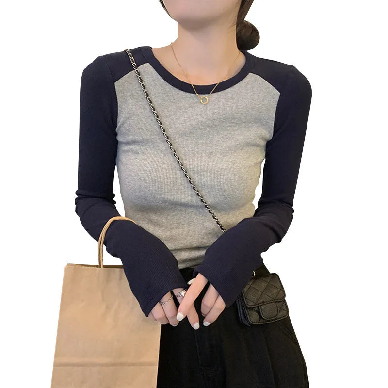Women's black viscose slim fit top with embroidered long princess sleeves.