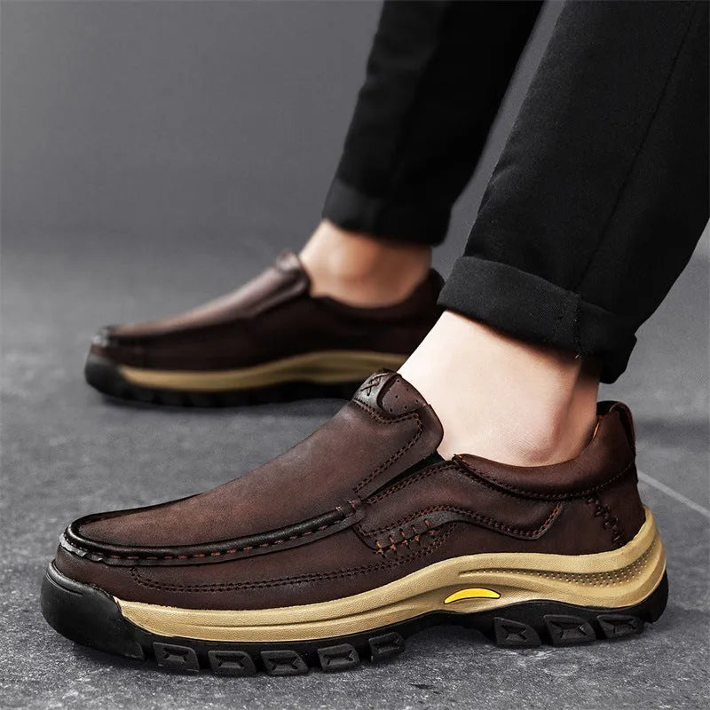 Men's black thick-soled leather mountaineering shoes with round toe and rubber sole.