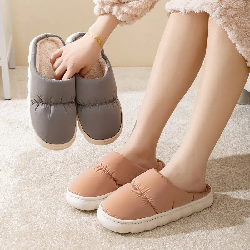 Blue down cotton slippers with a thick rubber sole and plush lining for indoor winter wear.