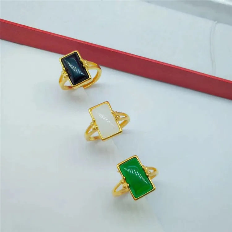 Adjustable brass gold-plated ring with a coloured gemstone in a national style design.