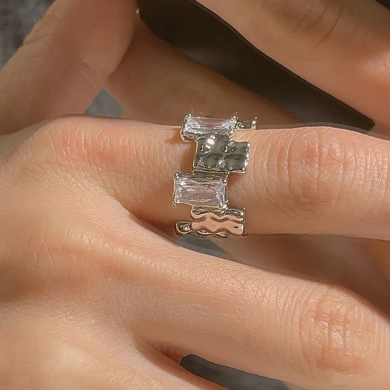 Silver geometric cross ring with open zircon setting and retro design