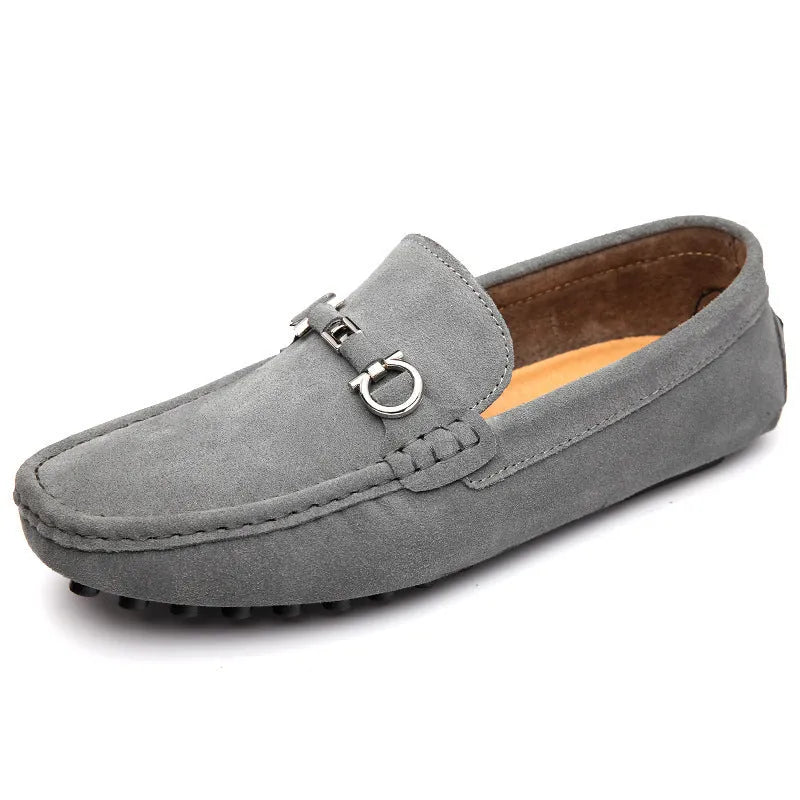 Men's black slip-on leather shoes with a square toe and matte finish on a plain background.