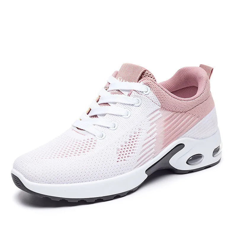 Women's pink Flyknit running shoes with a striped pattern, flat PVC sole, and lace-up front.