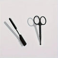 Black pet grooming brush with soft bristles for gentle eye area cleaning on dogs and cats
