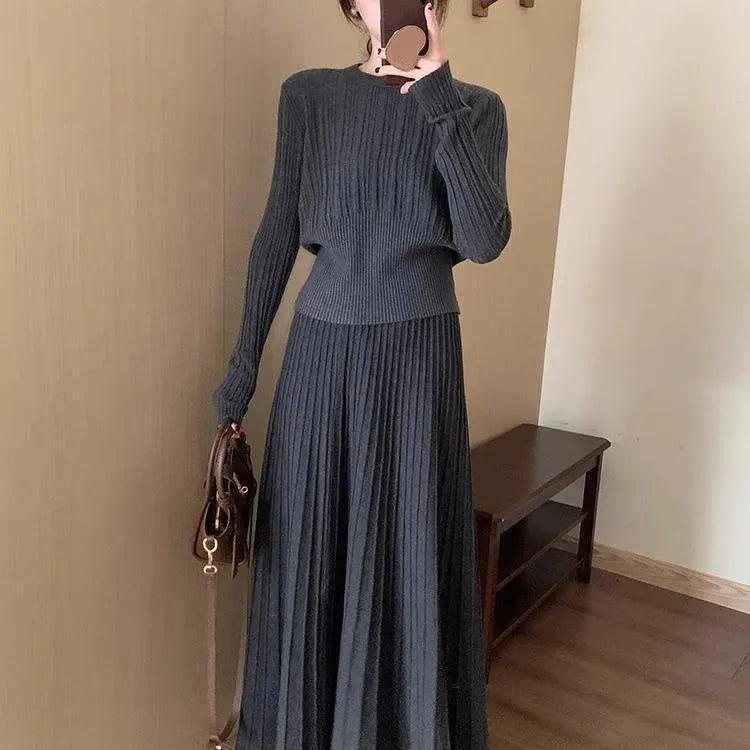 Dark grey knitted ethnic style dress suit with collage stitching, featuring a sweater and skirt.