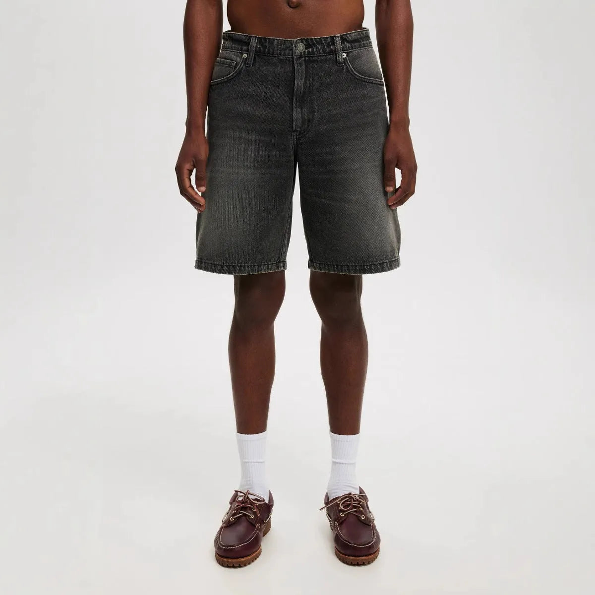 Men's loose straight-leg jeans in light blue denim on hanger