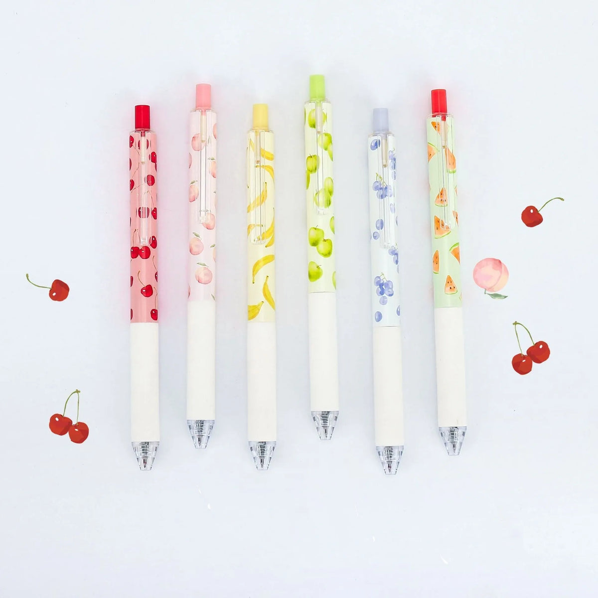Three fruit scented 0.5mm black ink click pens with plastic barrels and replaceable refills