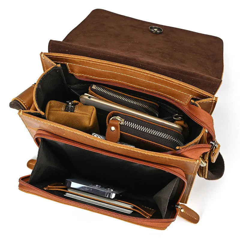 Men's brown cowhide leather crossbody bag with flip shoulder strap and retro style.