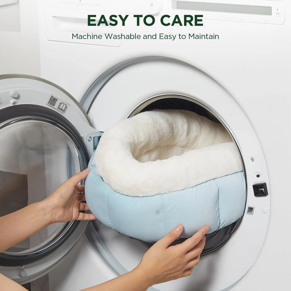 Round donut dog and cat bed in faux rabbit fur with anti-slip bottom and raised sides, available in five sizes