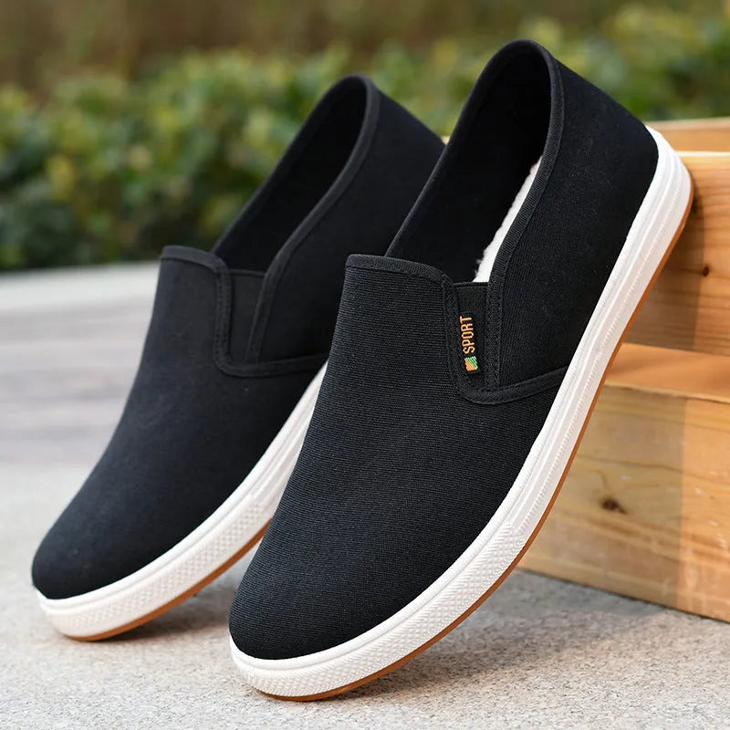 Men's black and blue low-top canvas slip-on shoes with round toe and composite soles